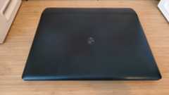 An Alienware 16 Area-51 laptop on a wooden desk