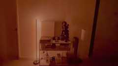 Nanoleaf Smart Multicolor Floor Lamp display red light beside a console table