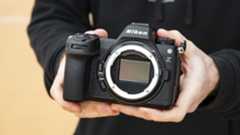 Nikon Z6 III camera in the hand with no lens attached and full-frame sensor on display