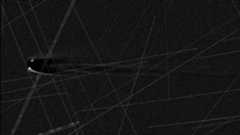 An image of a comet in black and white with lines streaking across the image. 