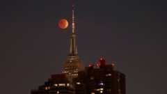  The blood-red full Beaver Moon passes behind the Empire State Building during a total lunar eclipse on November 8, 2022