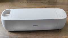 Cricut Explore 4 review: a white craft machine on a wooden table