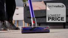 Close up of the floorhead on the Dyson V11 vacuum, with Lowest Price graphic overlaid