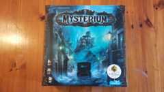 The Mysterium box on a wooden surface, seen from above