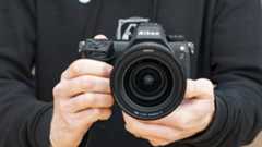 Nikon Z6 III camera in the hand, front on