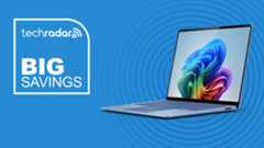 Microsoft Surface Laptop in sapphire on blue background with TechRadar big savings logo