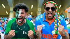 A Pakistani and an Indian fan pose for a photo before the start of the Asia Cup 2025 Twenty20 international cricket final between India and Pakistan at the Dubai International Stadium in Dubai on September 28, 2025. 