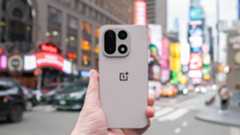 OnePlus 15 in Times Square New York City on the busy street showing the cameras and sides of the phone in addition to home screen panels and Settings menus