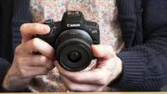 Canon EOS R100 camera in the hand