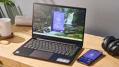 PrivadoVPN Free apps running on an open laptop and a mobile, lying on a desk.