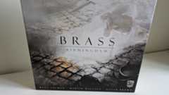 Brass: Birmingham box showing a puddle in a cobbled street, against a plain white wall