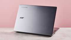 Back of Acer Chromebook Plus 516 open on desk with pink background