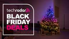 The Philips Hue Festavia string lights are pictured decorating a Christmas tree in a living room. To the right is a large badge which reads &quot;Tech Radar Black Friday Deals&quot;.
