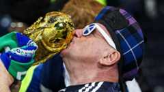 A Scotland fan kisses a replica of the Jules Rimet trophy.