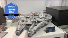 A Lego space ship in the shape of a disk at the rear and two pointed parts at the front is sitting on a white desk with the space.com logo in the top left corner.