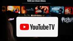 YouTube TV logo on a phone in front of a TV