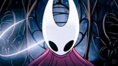 A screencap of Hollow Knight: Silksong&#039;s opening cutscene. A close-up shot of protagonist Hornet moments before she breaks out of a metal cage. Her curved white mask and red cloak are lit up as a glowing strand of silk surrounds her.