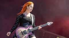 Serena Cherry on stage with her guitar