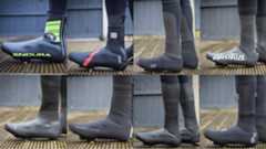 An image of a rider wearing the best winter overshoes on a wooden decking 