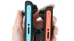 Official product image of someone holding the Game Tech one-handed grip with one hand.