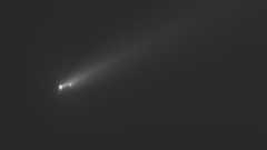 three fuzzy white dots leave a fuzzy trail on a black background