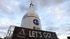a white cone-shaped capsule on a truck bed under a cloudy sky