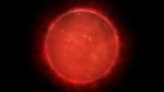 An illustration of a red giant star, where it glows red with heat in space