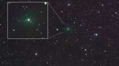 A glowing green light is seen in the center of a starry image from space but also in a white cutout box on the left part of the image