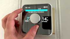 Person's hand controlling Hive Smart Thermostat manually