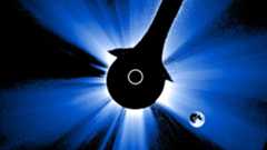 coronagraph view of the moon in the lower right corner and the sun in the center with the central disk blocked so only the outer corona is visible.