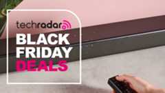 Someone turning on Sony HT-SF150 soundbar with words 'TechRadar: Black Friday deals' on left side