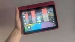 Hand holding Fire HD 8 Kids Pro tablet with Dandy&#039;s World gameplay on screen.