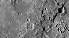 A gray image showing the fault lines, craters, and pockmarks on the surface of Mercury