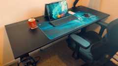 A black Secretlab Magnus Evo desk