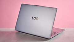 Rear three-quarter view of Lenovo LOQ Essential Gen 9 open on desk with pink wall in background