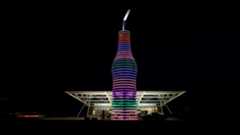 A giant soda sculpture is illuminated in front of Pops 66 in Oklahoma
