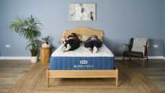 In this image we see two of our experts testing the comfort, support and motion isolation of the Bear Elite Hybrid Mattress in our sleep studio. Tester Eve Davies lies on the left of the mattress on her front. Tester Ruth Jones lies on the right of the mattress on her back.