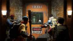Back 4 Blood - four players stand together with weapons ready to enter a door labeled &quot;Exit: Danger&quot;