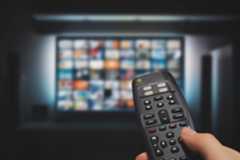 A remote control pointing at a TV