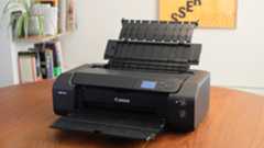 A photograph of the Canon imagePROGRAF PRO-310 printer with input and output trays unfolded