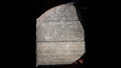 Ancient Egyptian Rosetta Stone. It is a giant stone with 3 types of writing carved onto it: Greek, Egyptian, and another form of Egyptian writing.