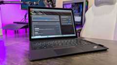 The Lenovo ThinkPad X12 Detachable (Gen 2) on a desk with its kickstand deployed, and keyboard and stylus attached, showing the Lenovo Commercial Vantage app.