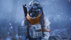 Arc Raiders: An upper-body shot of a character wearing warm clothes as they fiddle with something out of shot in a snowy environment.