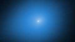 A white light of the comet 3I/ATLAS is surrounded by a blue glow against a black background
