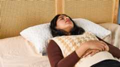 Tom's Guide Sleep Writer lying on her back on the Coop Original Adjustable Pillow