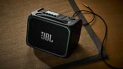 A JBL BandBox Trio guitar amp on a rug