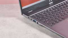 Close-up of left-side ports on Acer Chromebook Plus 514, on desk with pink background