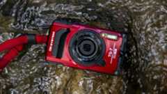 The OM System Tough TG-7 camera lying in a stream