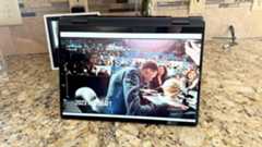 A Dell Inspiron 14 2-in-1 laptop playing Netflix on a kitchen counter.