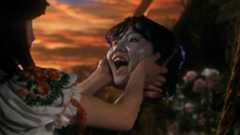 A girl's head smiling during one of the best scary movies, House. 